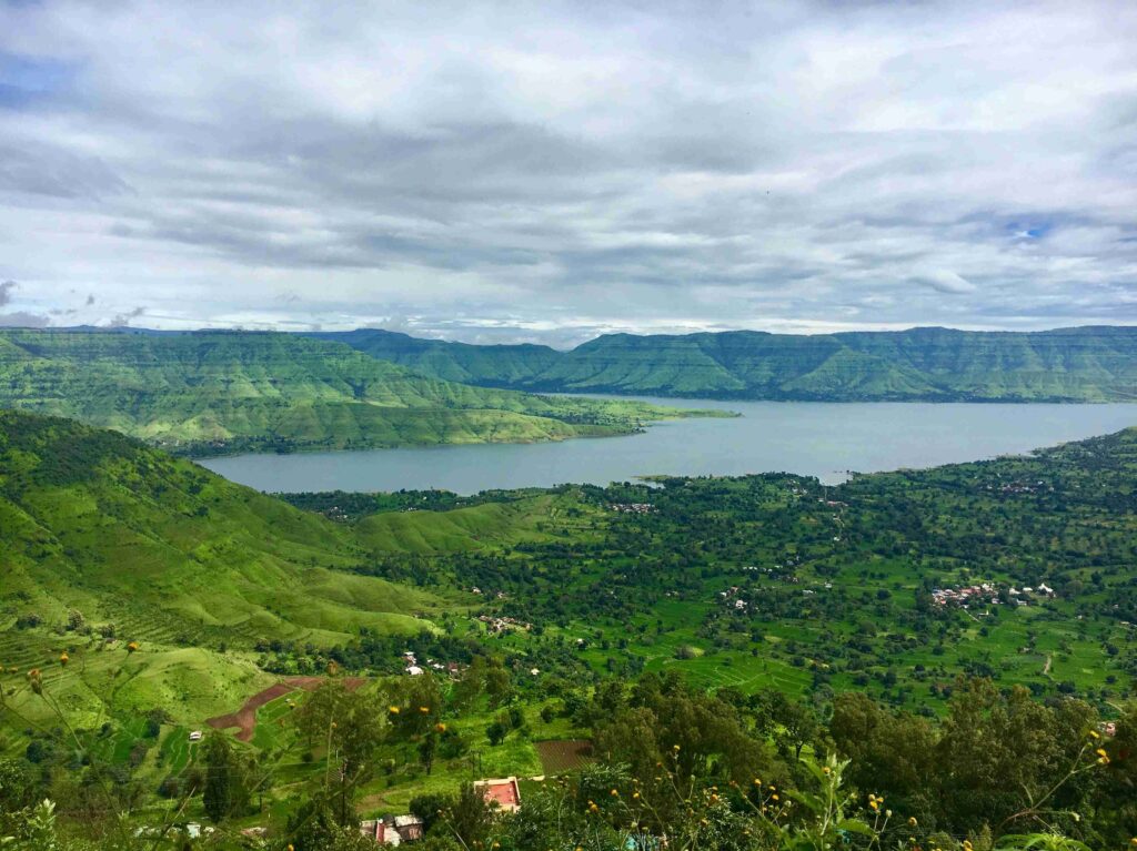 a green hills and a body of water