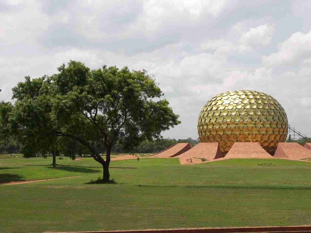 a large gold dome in a grassy field