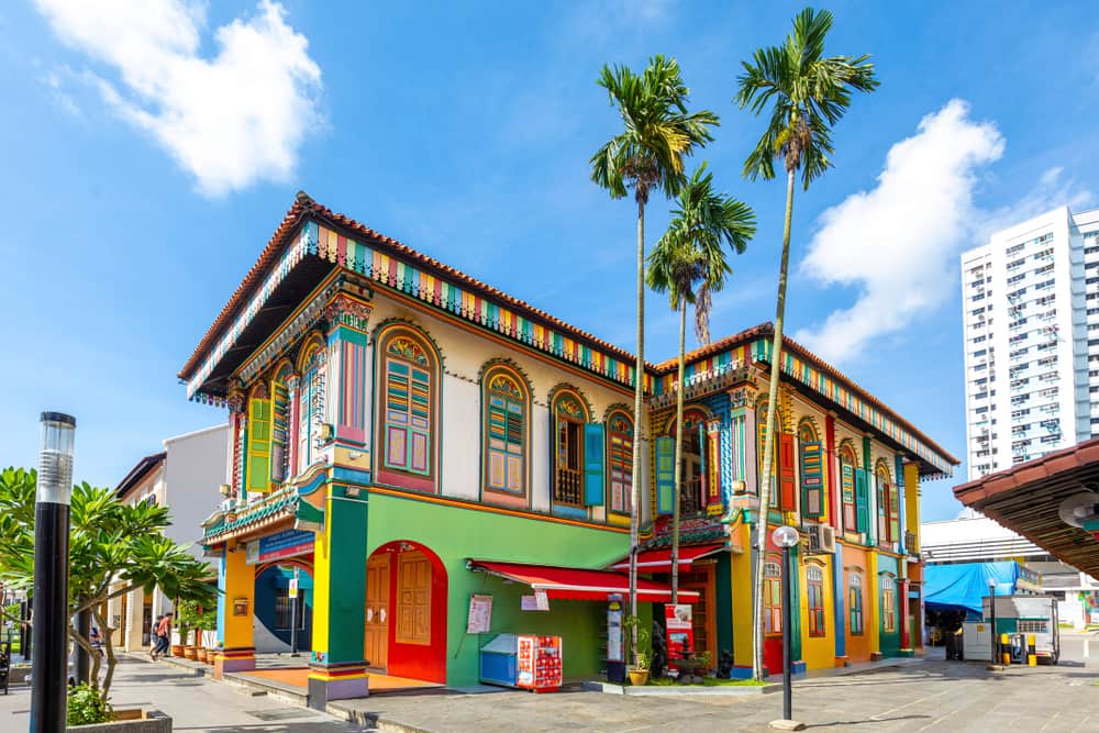 a colorful building with palm trees