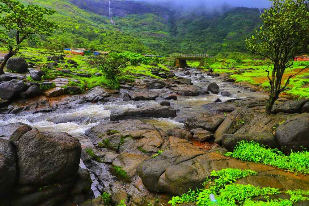 a river running through a valley in Lonavala