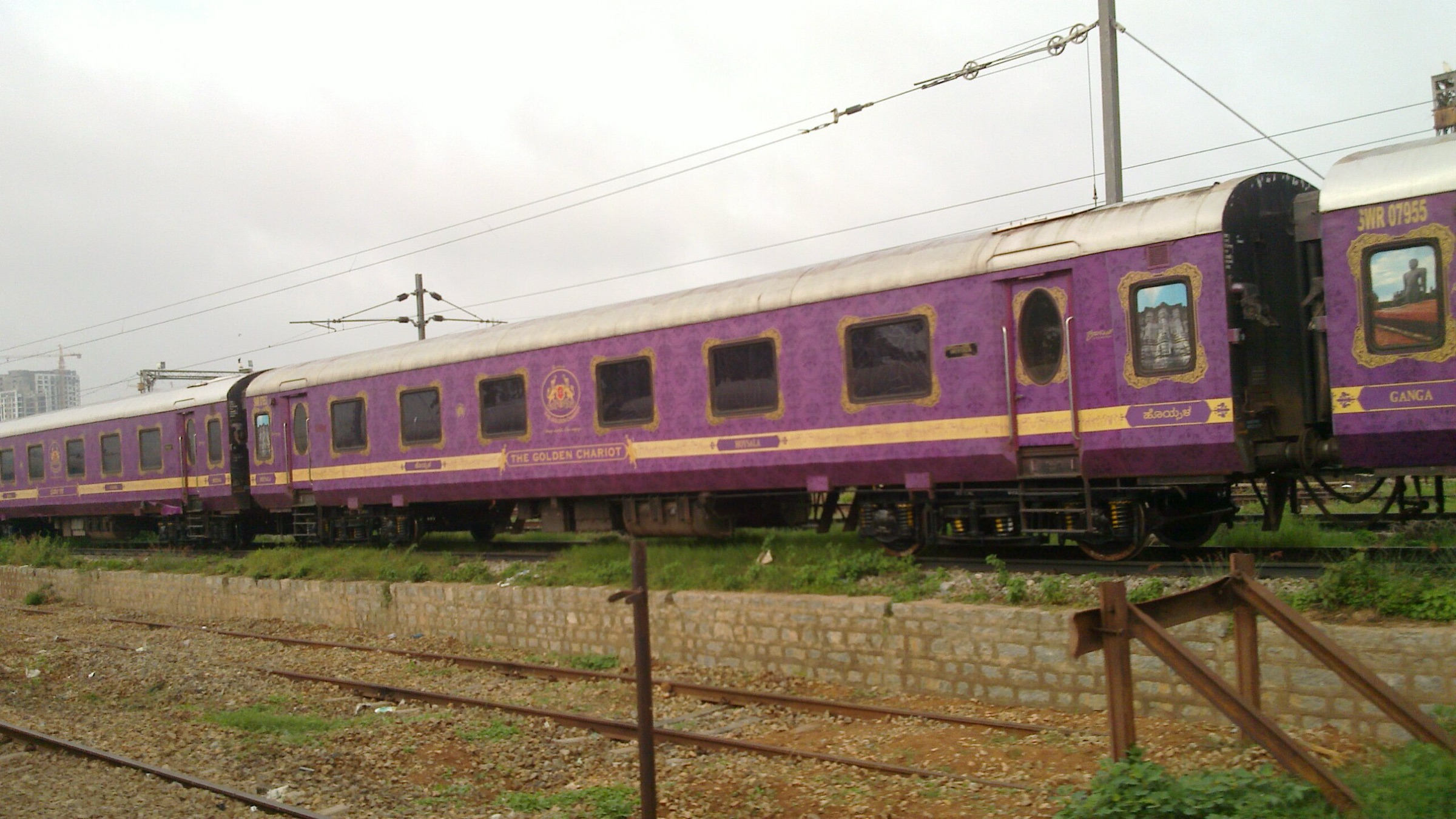 The Golden Chariot in its purple and gold livery alongside the platform