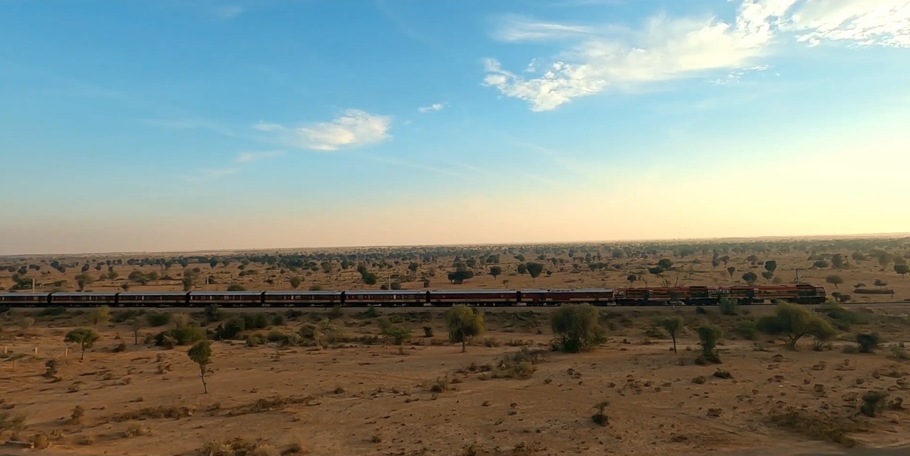 Maharajas' Express running through the Thar Desert at golden hour