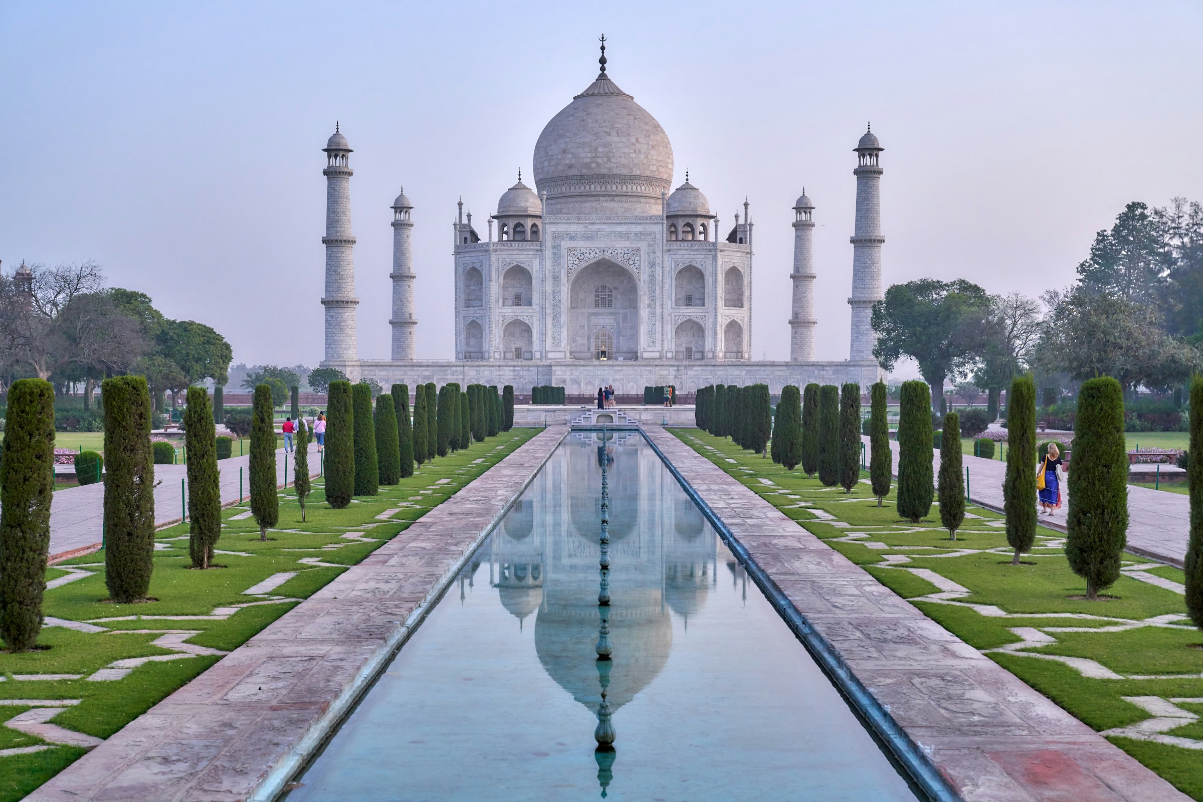 The Taj Mahal mirrored in still water at dawn